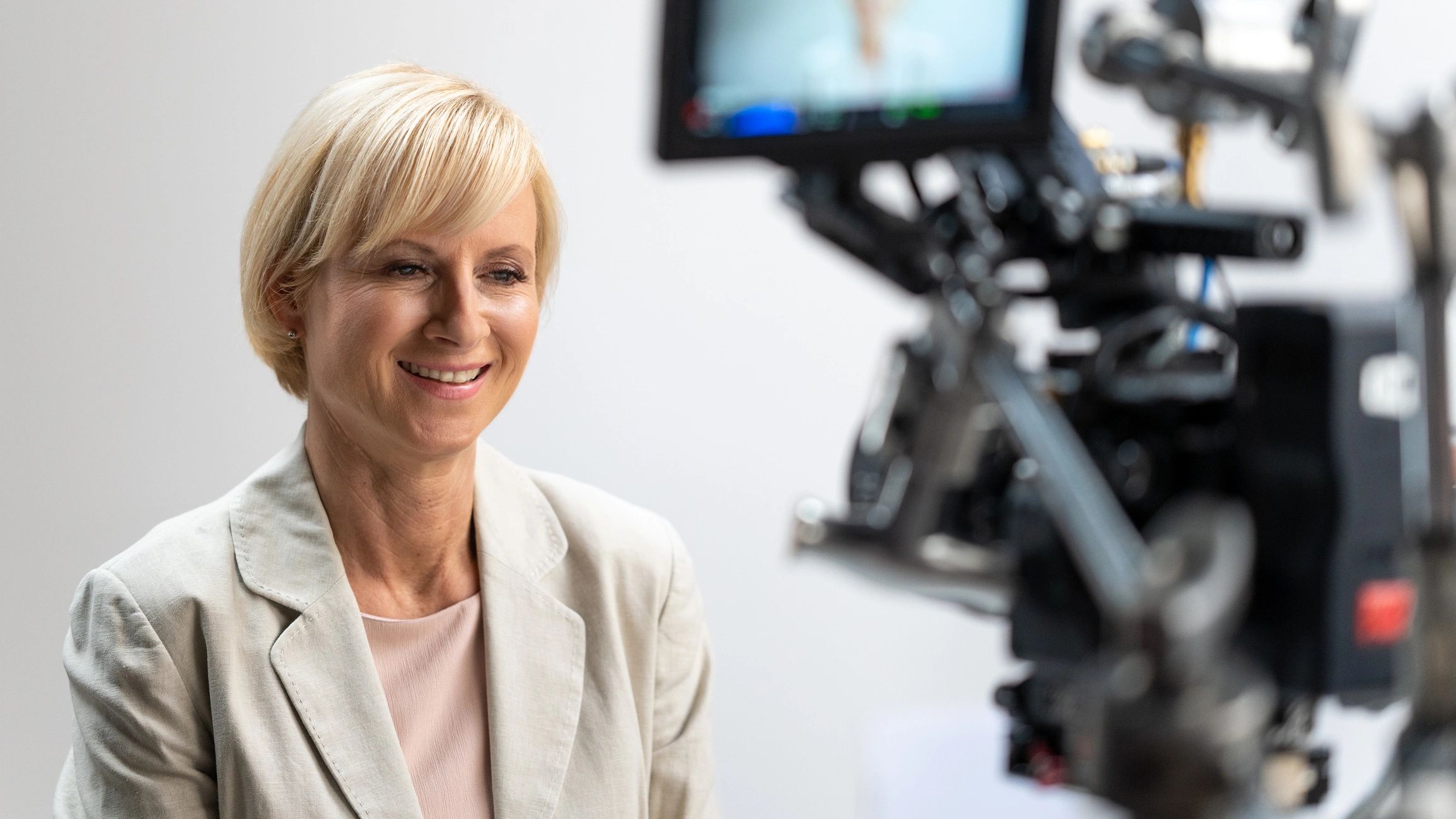 Reporter recording an interview with a professional camera