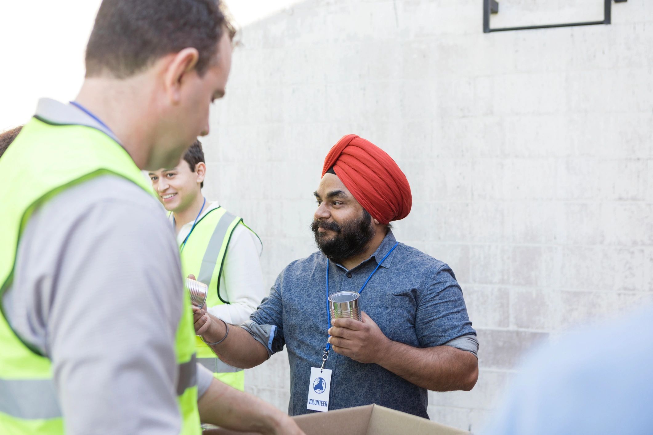 Volunteer organizing food boxes at a community drive