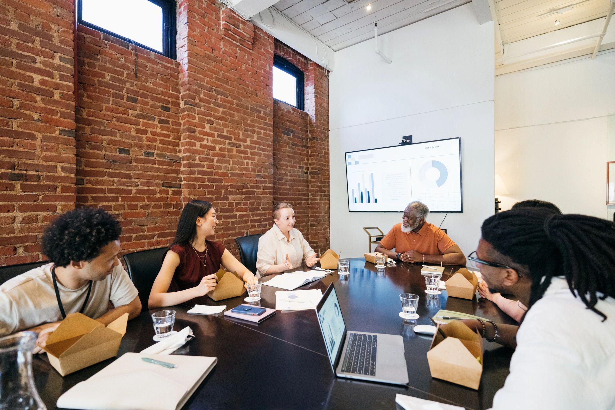 Collaborative media team meeting in a newsroom setting