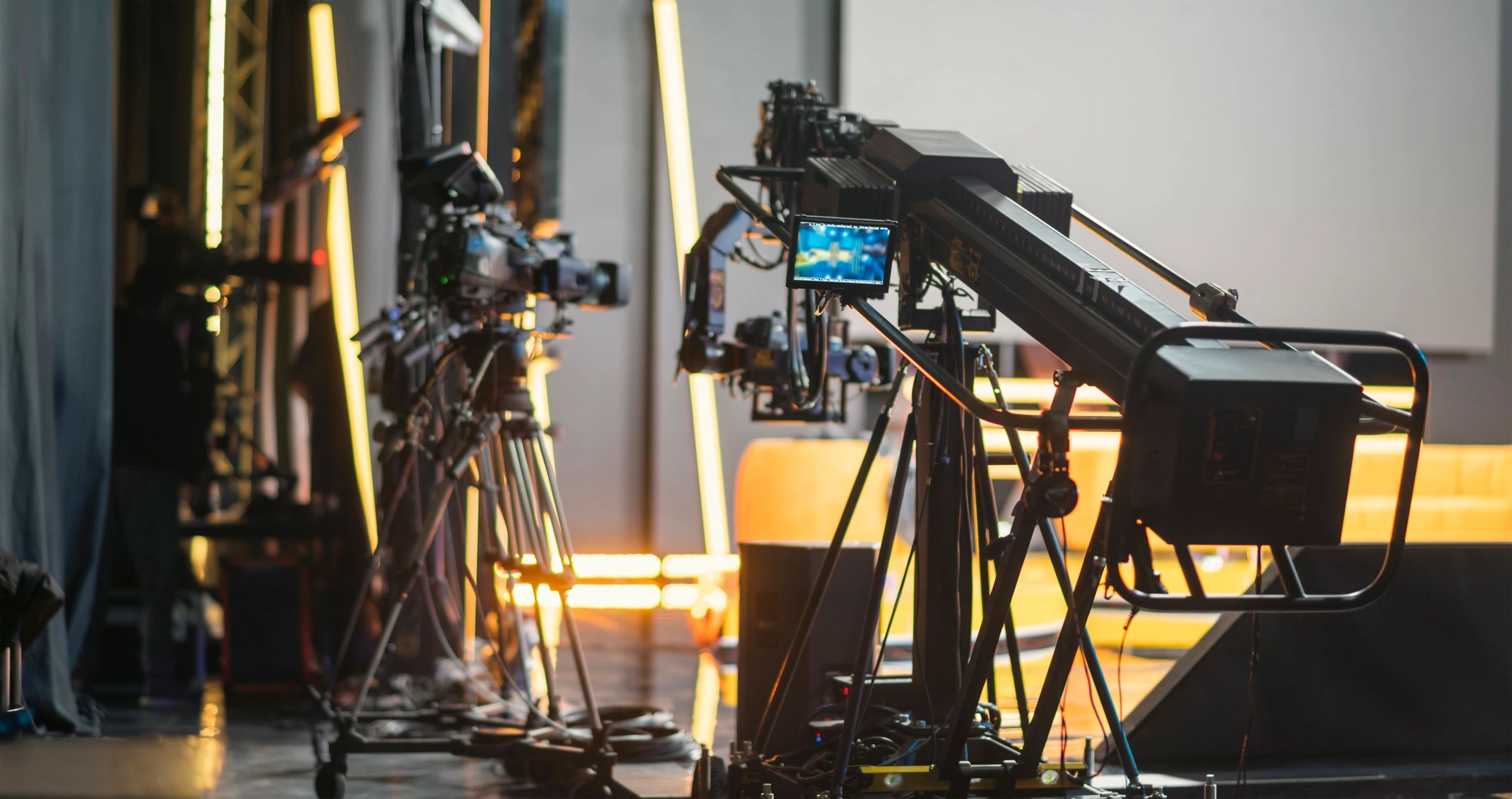 Professional television newsroom with cameras and live monitors
