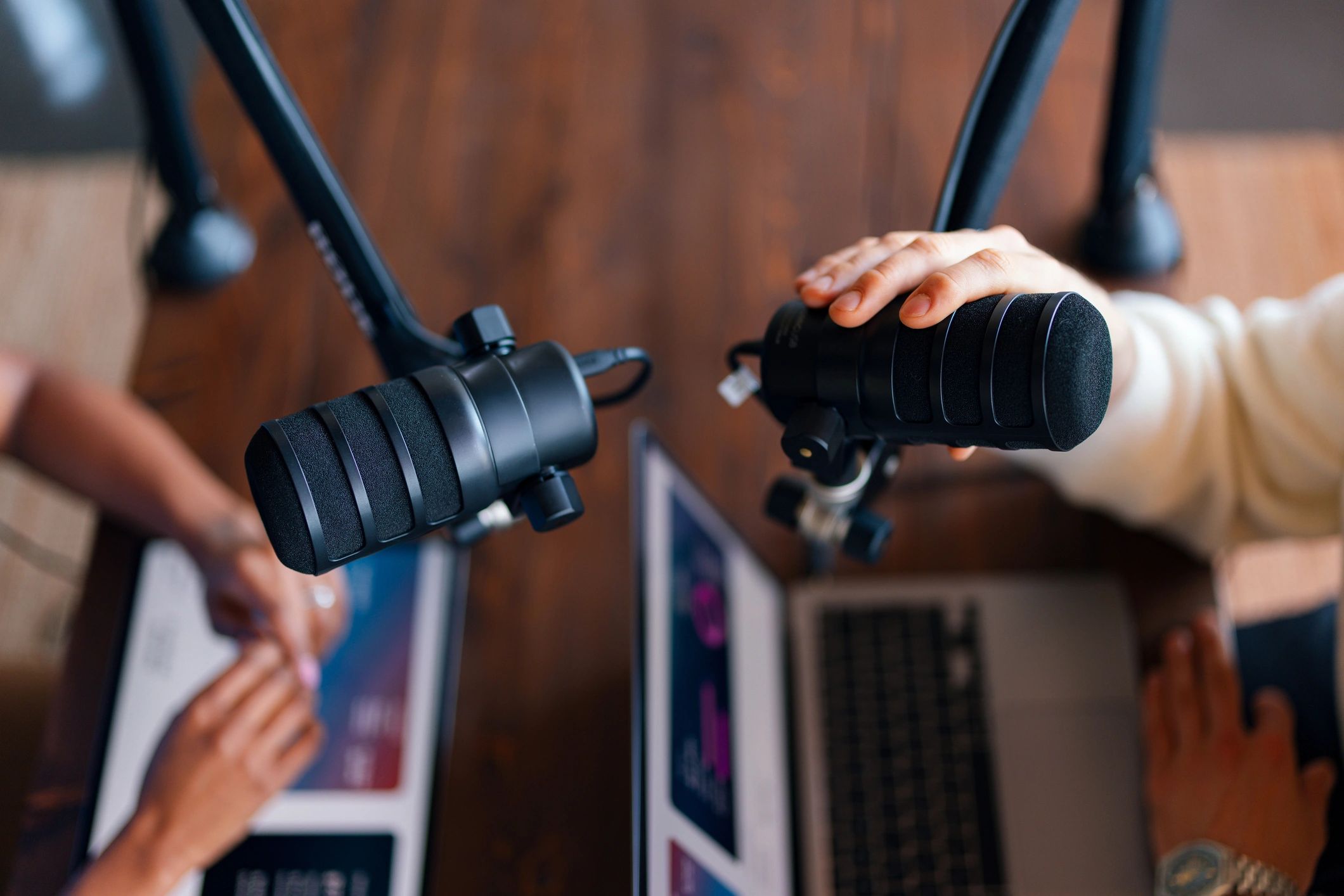 Two hosts recording an interview in a professional studio